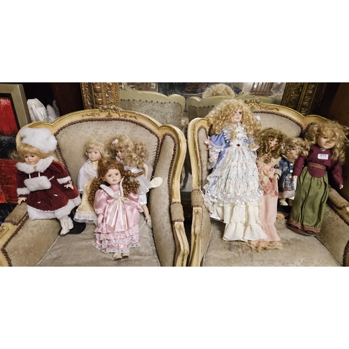 571 - 8 porcelain Dolls, all wearing colourful dresses (1 is a Santa Doll)