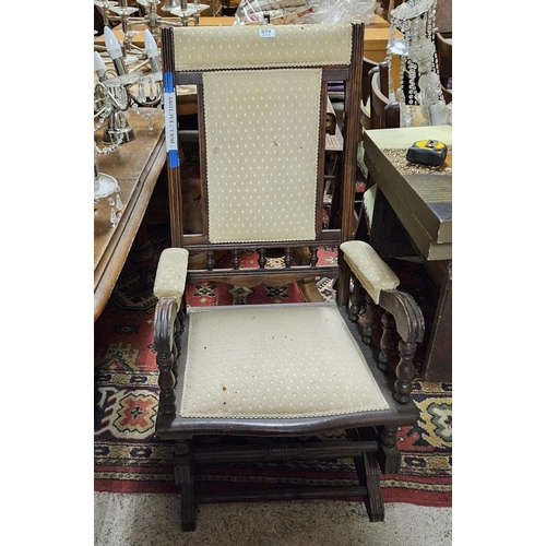 579 - Walnut framed Rocking Chair, cream padded headrest, back and seat