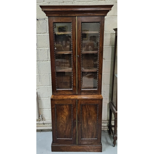 107 - Fine 19thC Mahogany Bookcase - compact sized - the tiered crown above 2 glazed doors and 2 cabinet d... 