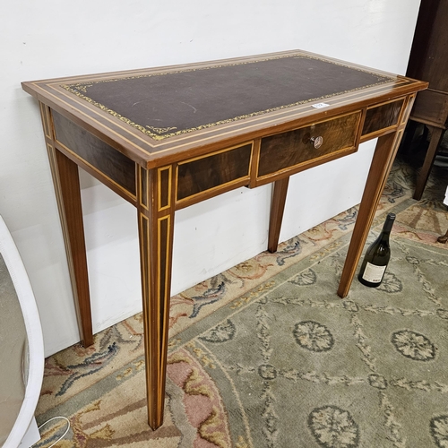 112 - Writing Table 77cmH x 90cmW, with a brown leatherette top and tapered legs, inlaid designs