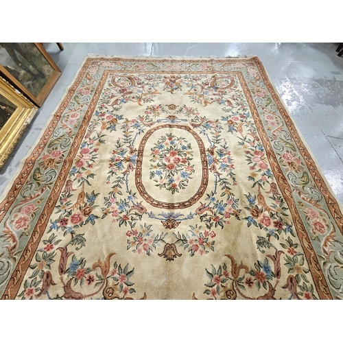 163 - Chinese Wool Carpet, beige ground with a central field of pink, red and blue flowers, green and red ... 