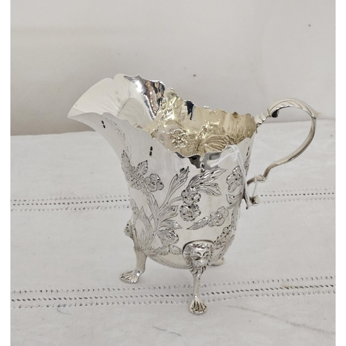 219 - Dublin Silver Cream Jug, decoratively embossed with floral sprays, raised on 3 paw feet with lion he... 