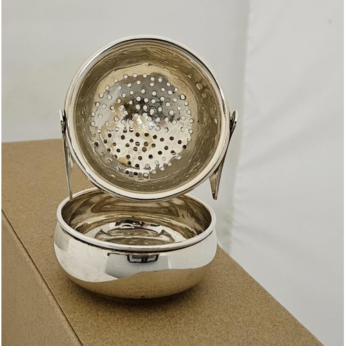 458 - London Silver hallmarked tea leaf strainer on a hinged holder with waste bowl, 6cmH, hallmarked 1913