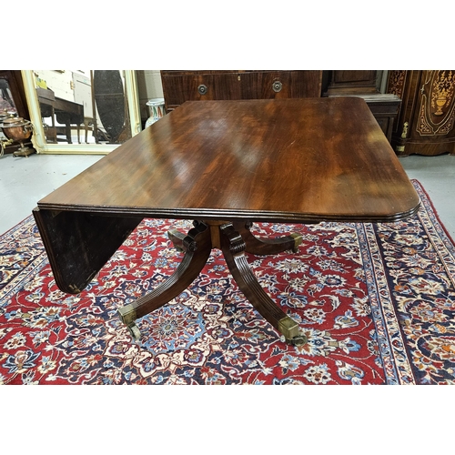 71 - Regency Mahogany Dining Table on a tripod splayed leg base with cast brass toes and castors (varnish... 