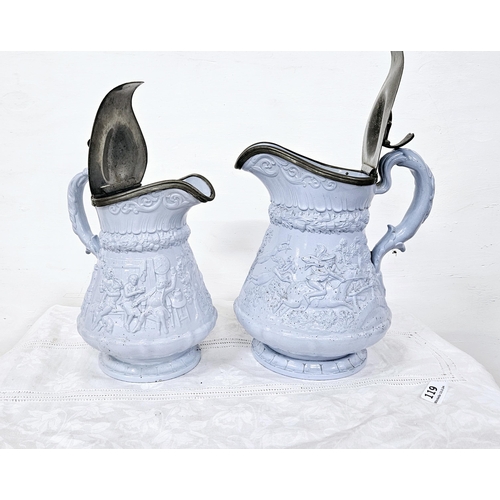 119 - 2 Victorian Ridgeway Jugs (graduating sized), blue glazed, with hinged pewter lids, hunting and tave... 