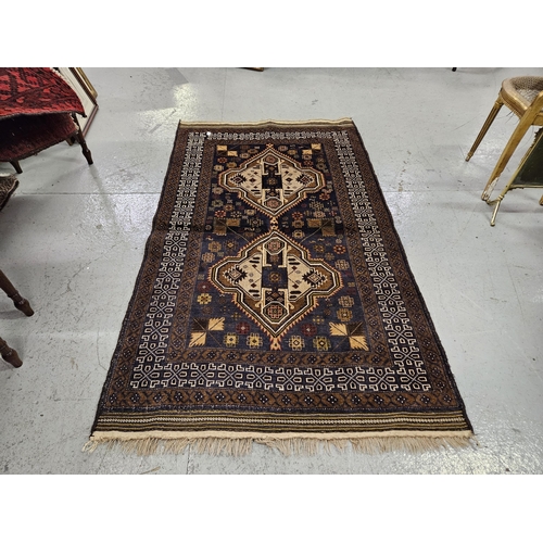 178 - Fine woven Afghan Buluchi Nomadic Rug, double medallion columns, brown ground with hints of green, 2... 