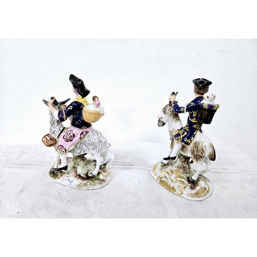 370 - Pair of Porcelain family Companions  figures seated on goats 15cmH (2)