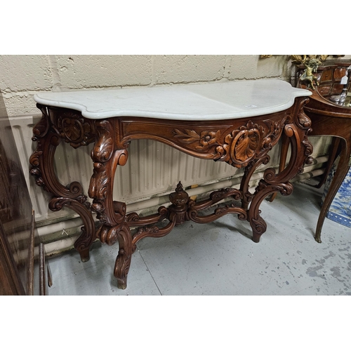 105 - Ornate 20thC Mahogany Console Table, with ornately scrolled legs and floral designs, covered with a ... 