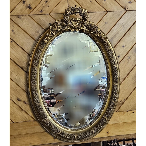 260 - Oval Shaped Gilt Frame Wall Mirror, ornate borders, shaped pediment and bevelled glass, 70cmW x 95cm... 