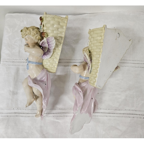 267 - Pair of Continental Porcelain decorative Wall Pockets - cherubs supporting baskets, each 24cmH