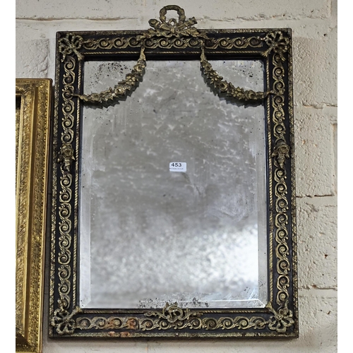 453 - French Wall Mirror, bevelled glass, the ebony finished frame mounted with decorative metal designs a... 