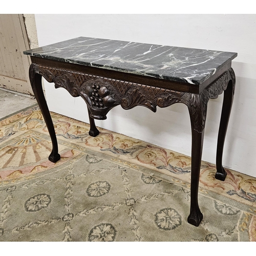 43 - Mid-20thC Mahogany Hall Table, with a green marble top above the carved apron featuring a basket of ... 