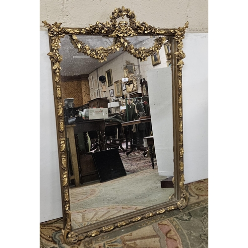 86 - Carved Gilt Framed Overmantle Wall Mirror, a decorative wreath above an applied floral garland, 1.44... 