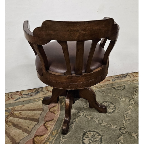 12 - Mid-20thC Office Swivel Chair with a brown leatherette seat, adjustable height, on a 4-legged base