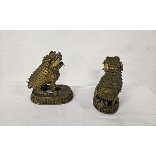 128 - Pair of Oriental gilt metal Guardian Foo Dogs, on oval bases, 18cmH