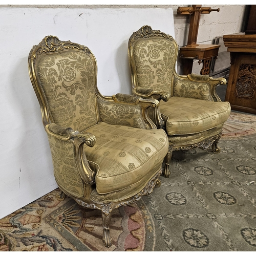 18 - Pair of carved gilt framed Armchairs, on cabriole front legs, the seats, backs & cushions covered wi... 