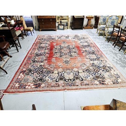 235 - Old Persian Wool Floor Rug, red ground with a central medallion of greens and blues, 4.1m x 3.08m (s... 