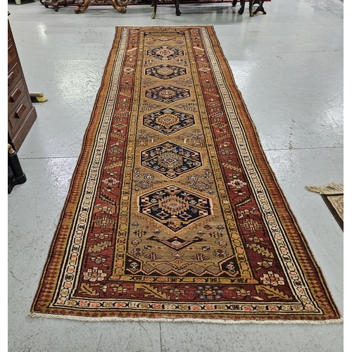 239 - Large dark gold ground vintage Persian Heriz runner, medallion design, with a surrounding terracotta... 