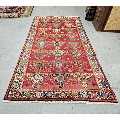 240 - Full pile red ground Persian Kaskai Tribal Rug, unique design with a multi coloured field of red, or... 