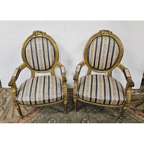 4 - Matching Pair of carved Giltwood framed Armchairs, the backs, seats and padded arms covered with blu... 