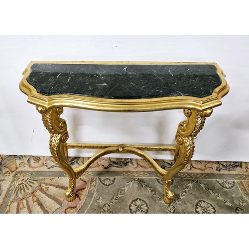 56 - Louis IX Style Carved Console Table, painted gold, serpentine shaped, the top inset with a shaped gr... 