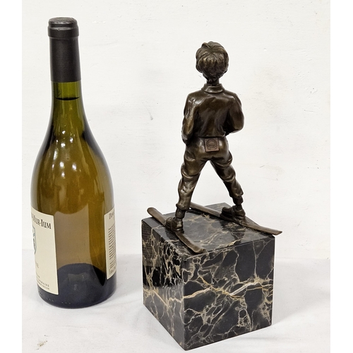 75 - French Table Bronze - Boy on Skis, on a tall black and brown marble base, stamped 