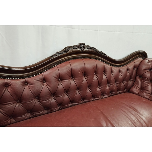 27 - WMIV Mahogany Settee, with floral motif to the shaped back, on 4 turned legs, castors, red buttoned ... 