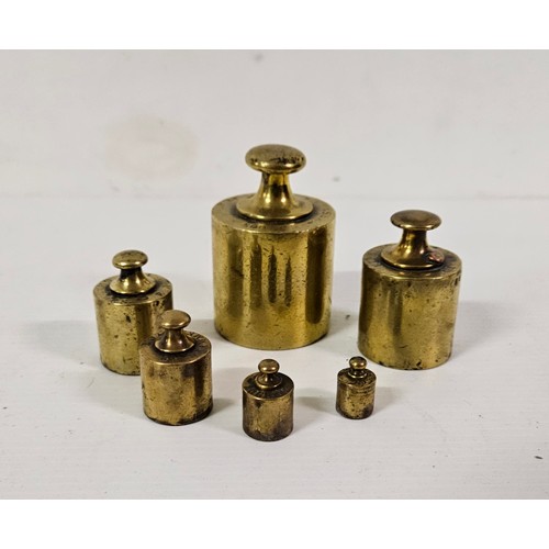 26 - Set of 6 graduating brass round weights from 10 grams to 500 grams, stamped at the base EDH