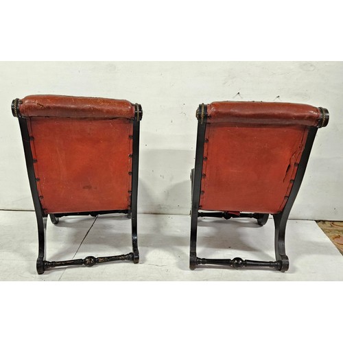 57 - Matching Pair of Regency ebonised low-seat Slipper Chairs, with worn crimson hide seats, brass trims... 