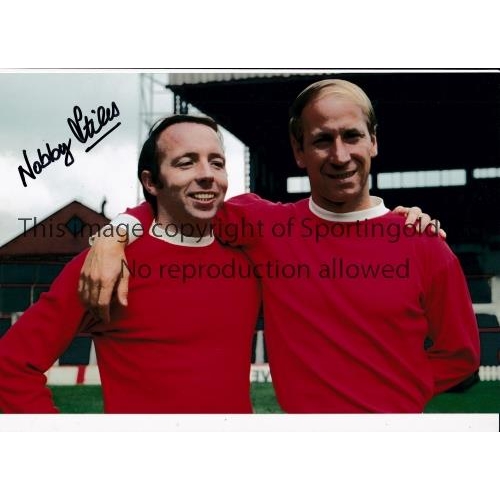 474 - NOBBY STILES       Autographed 12 x 8 col photo of Stiles posing with team mate Bobby Charlton of Ma... 