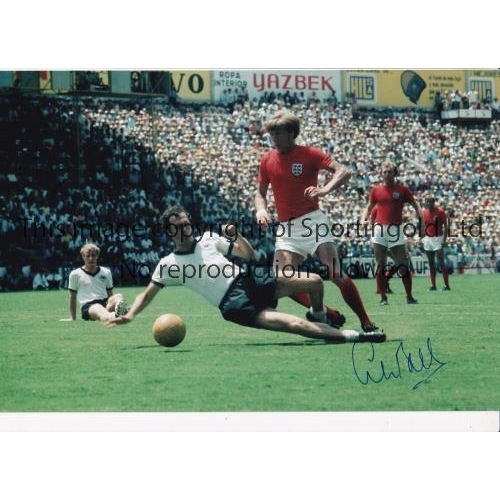 646 - COLIN BELL 1970      Two autographed 12 x 8 photos of Bell gliding by a challenge from Germany's Fra... 