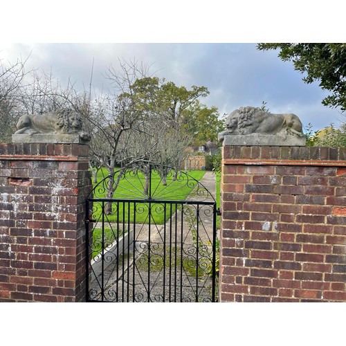 62 - A PAIR OF RECUMBENT STONE LIONS, reconstituted stone.
71cm x 34cm