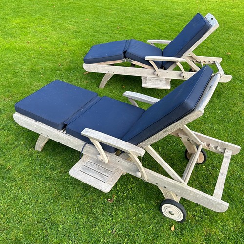 66 - A PAIR OF INDIAN OCEAN SUN LOUNGERS, with Indian Ocean blue upholstered cushions.
All labelled.