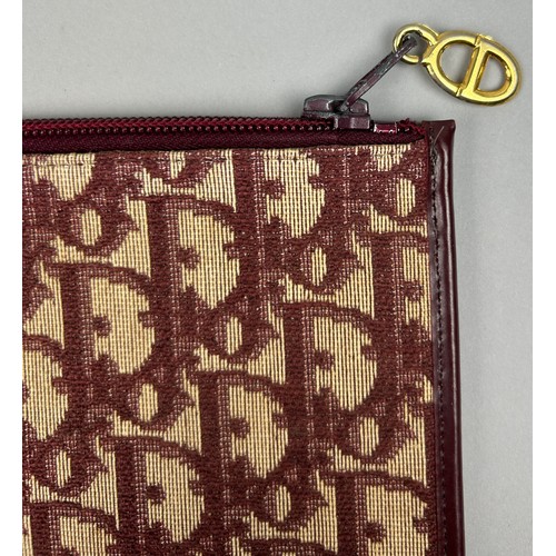 119 - A CHRISTIAN DIOR CLUTCH BAG AND PURSE, both with Dior red and beige monogram (2) 

Stamped within.