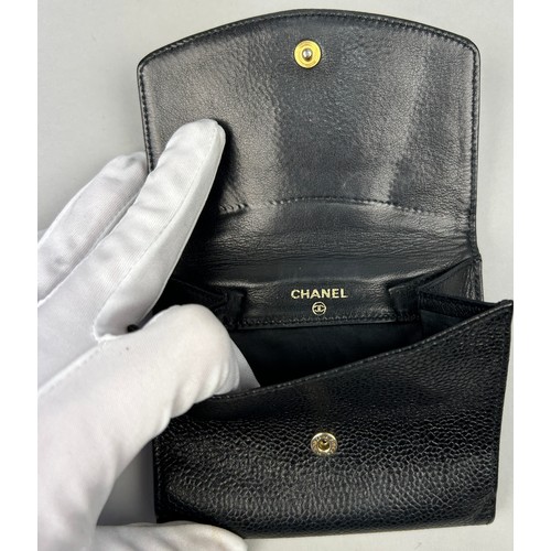 122 - A CHANEL BLACK 'CAVIAR' LEATHER BI-FOLD PURSE WALLET, stamped within 'Made in Italy' and 'Chanel'.

... 