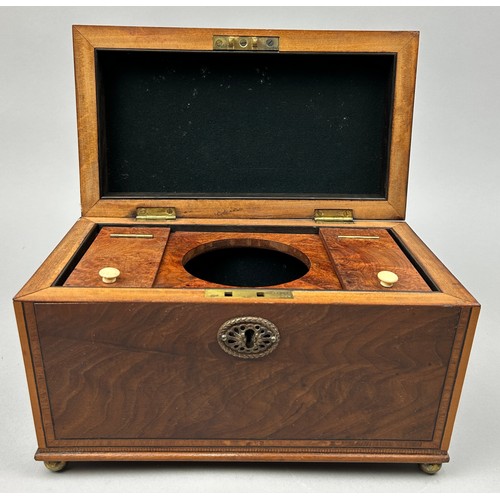 189 - A GOOD REGENCY SHERATON DESIGN TEA CADDY, with rising lid veneered in figured mahogany. The interior... 