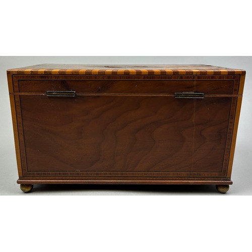 189 - A GOOD REGENCY SHERATON DESIGN TEA CADDY, with rising lid veneered in figured mahogany. The interior... 