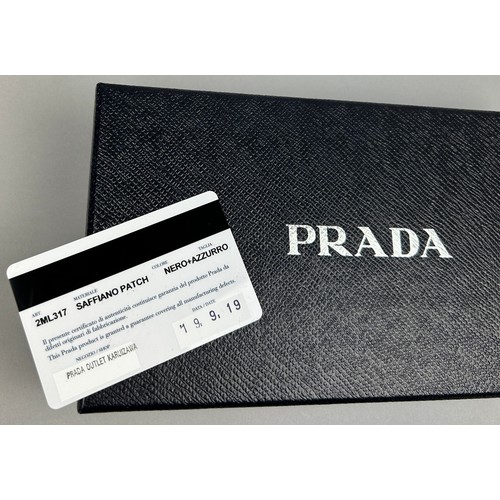 124 - A PRADA WALLET 2019 SAFFRANO PATCH NERO AND AZZURRO, zipped with inner compartments.

With box and c... 