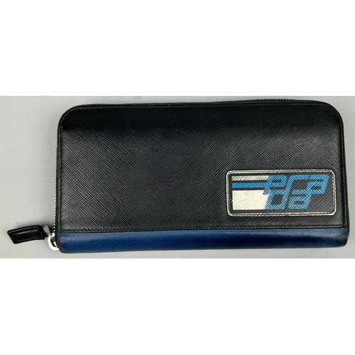 124 - A PRADA WALLET 2019 SAFFRANO PATCH NERO AND AZZURRO, zipped with inner compartments.

With box and c... 