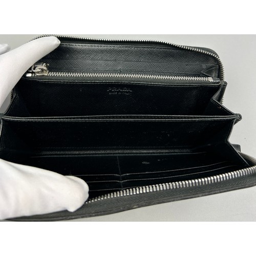 124 - A PRADA WALLET 2019 SAFFRANO PATCH NERO AND AZZURRO, zipped with inner compartments.

With box and c... 