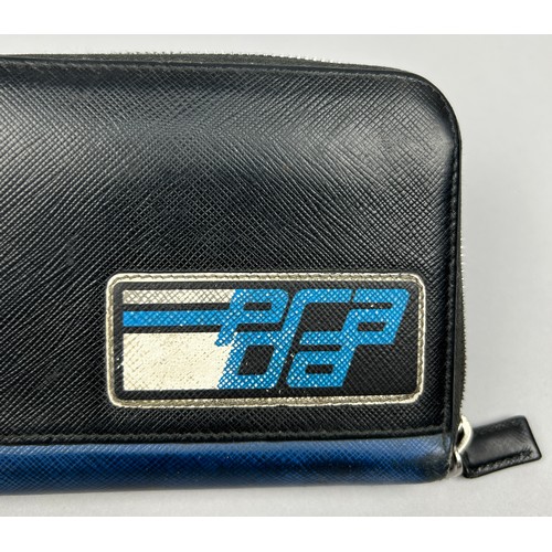 124 - A PRADA WALLET 2019 SAFFRANO PATCH NERO AND AZZURRO, zipped with inner compartments.

With box and c... 