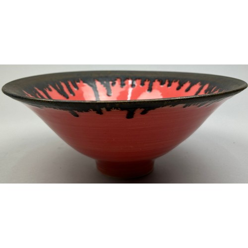 168 - A STUDIO POTTERY CERAMIC VERMILLION GLAZED BOWL WITH BRONZED RIM, in the manner of Lucie Rie.

25.5c... 