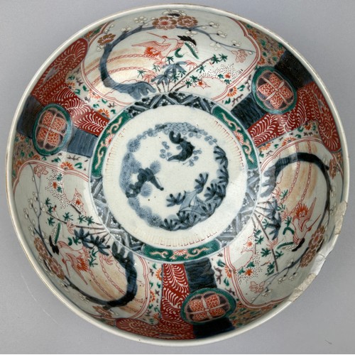 177 - A JAPANESE PORCELAIN BOWL, decorated with imagery of cranes and blossom trees in the Imari palette.