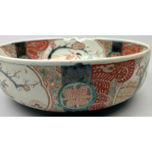 177 - A JAPANESE PORCELAIN BOWL, decorated with imagery of cranes and blossom trees in the Imari palette.