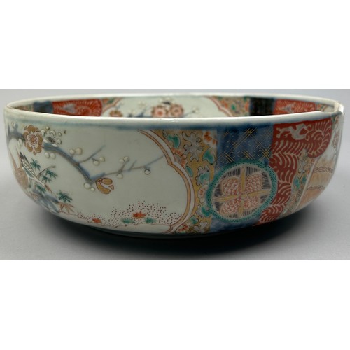 177 - A JAPANESE PORCELAIN BOWL, decorated with imagery of cranes and blossom trees in the Imari palette.