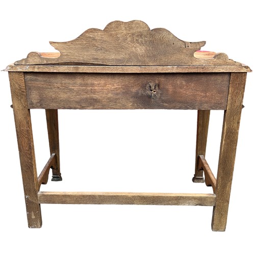 98 - A JACOBEAN REVIVAL GREEN MAN CARVED OAK CONSOLE TABLE, with singular sliding drawer carved with swag... 