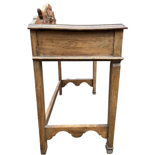 98 - A JACOBEAN REVIVAL GREEN MAN CARVED OAK CONSOLE TABLE, with singular sliding drawer carved with swag... 