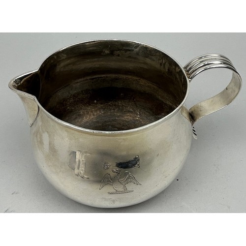 155 - A LARGE SILVER JUG WITH AN ENGRAVED EAGLE CREST

Weight: 414gms