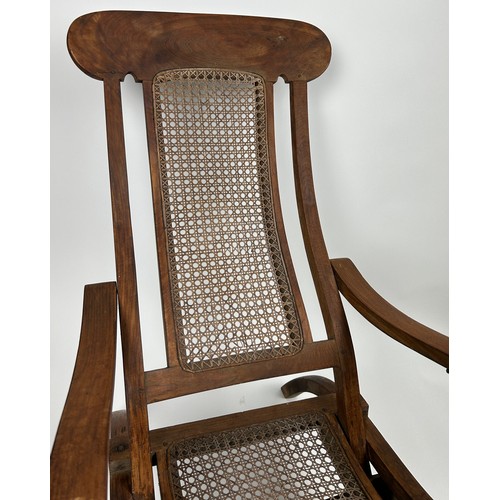 96 - A RECLINGING STEAMER ARMCHAIR CIRCA 1920, rattan cane panelled.