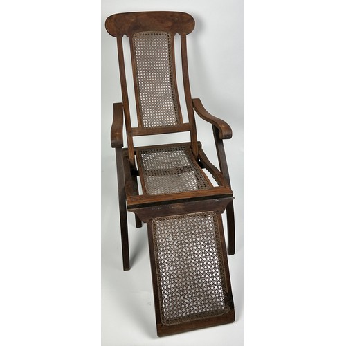 96 - A RECLINGING STEAMER ARMCHAIR CIRCA 1920, rattan cane panelled.